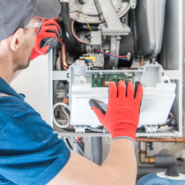technician inspecting furnace