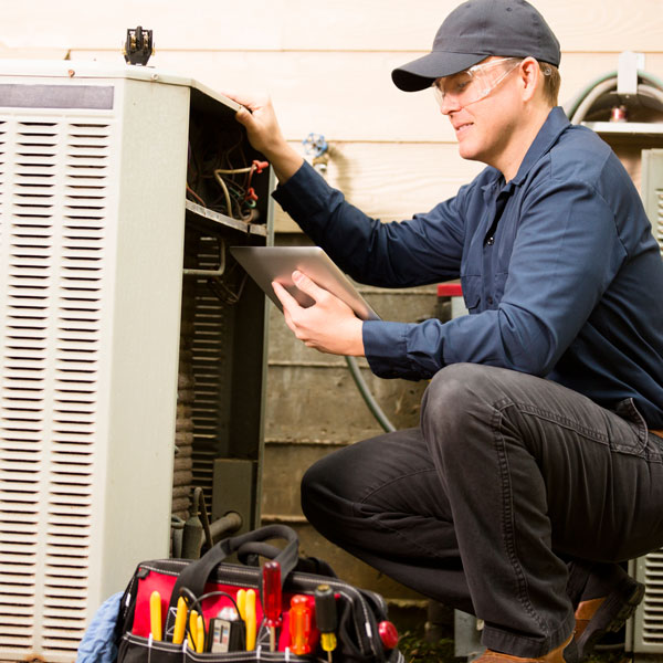 technician repairing HVAC unit