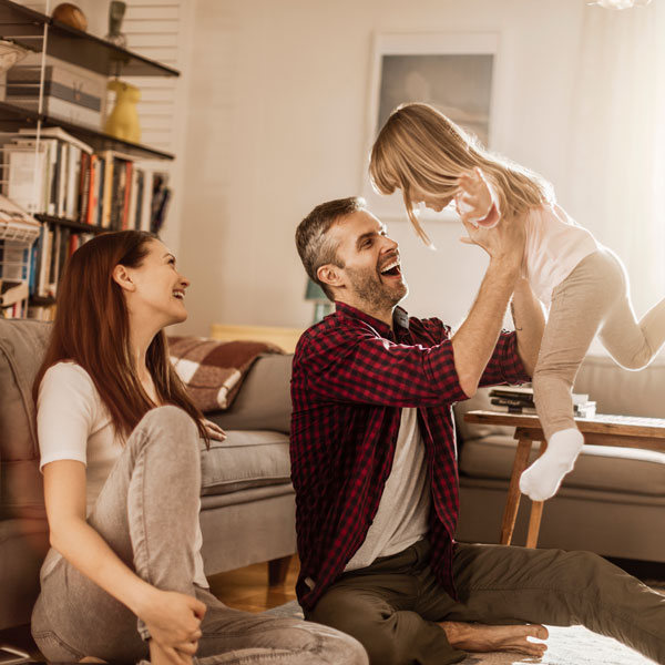 family of three playing in living room